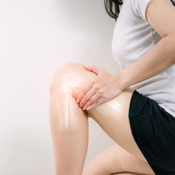 woman holding her knee with diagram of joint