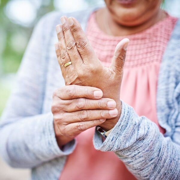 woman holding her hand with joint pain